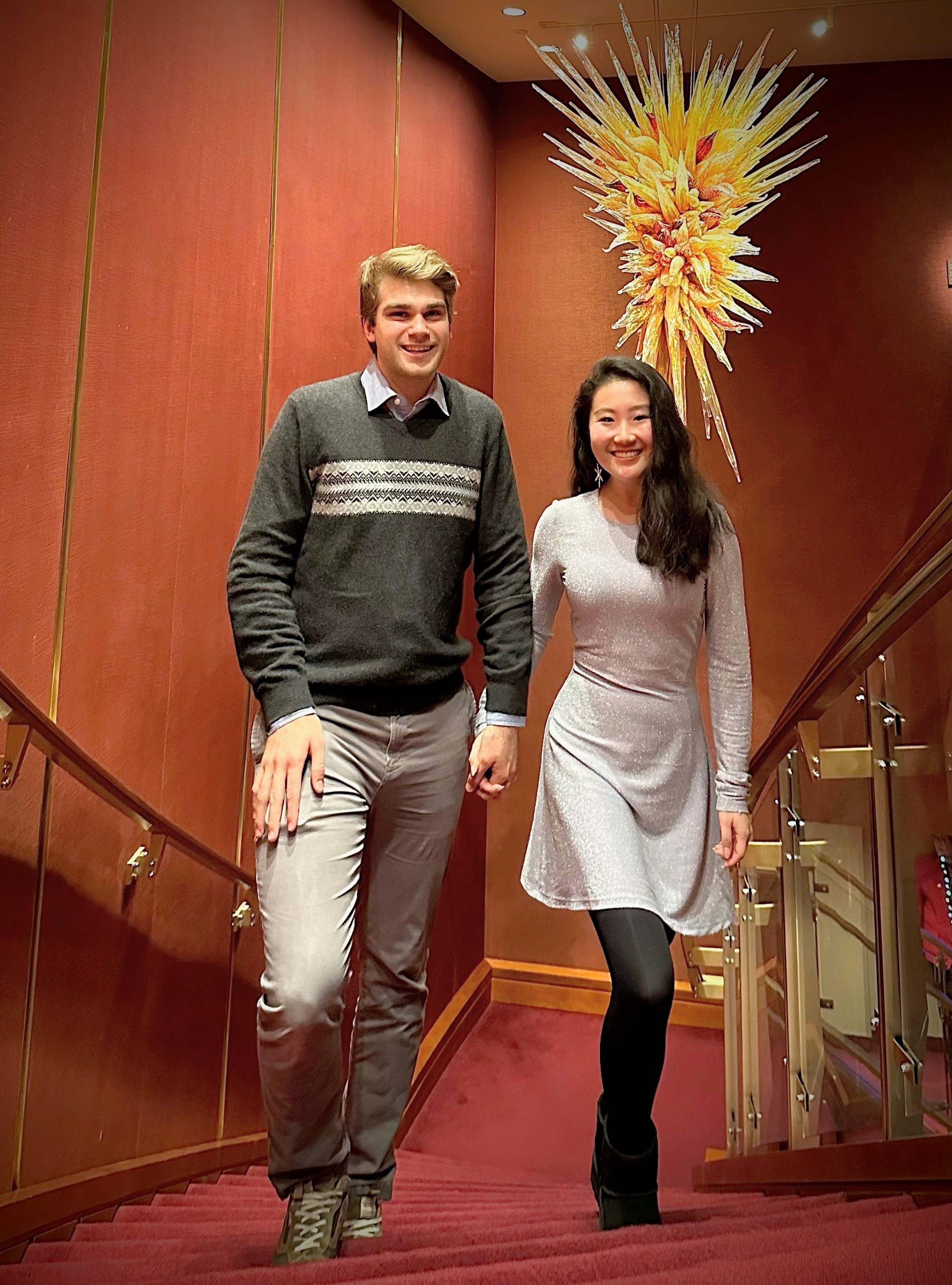 &lt;# Micah and Victoria on red stairs at the Kennedy Center #&gt;