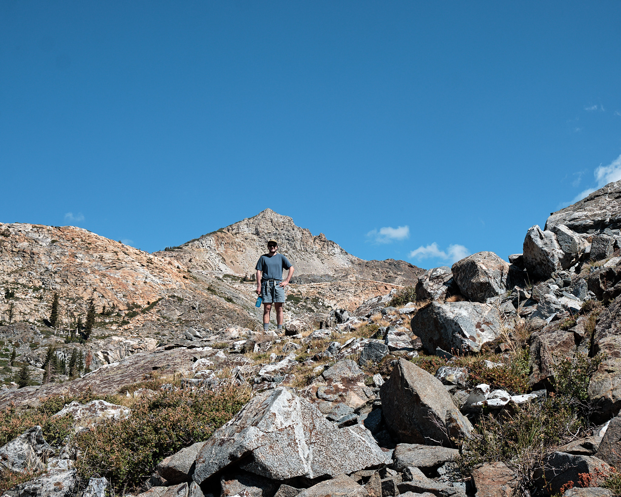 &lt;# Micah climbing up the trail towards a mountain #&gt;