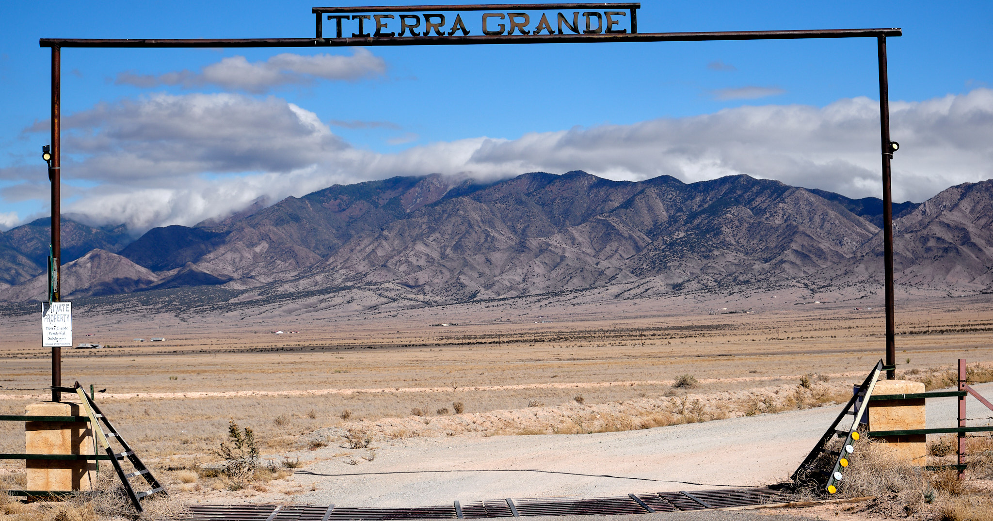 expansive landscape under a sign that reads Tierra Grande