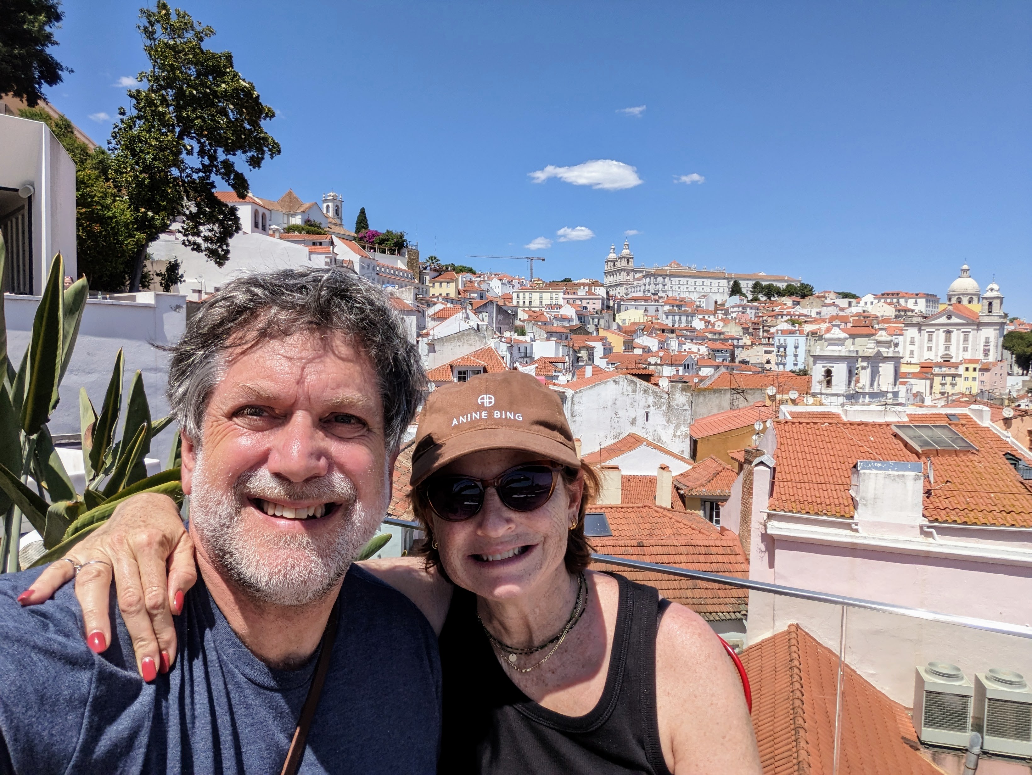 &lt;# Jeremy and Audrey look over red rooftops in the Alfama district of Lisbon #&gt;