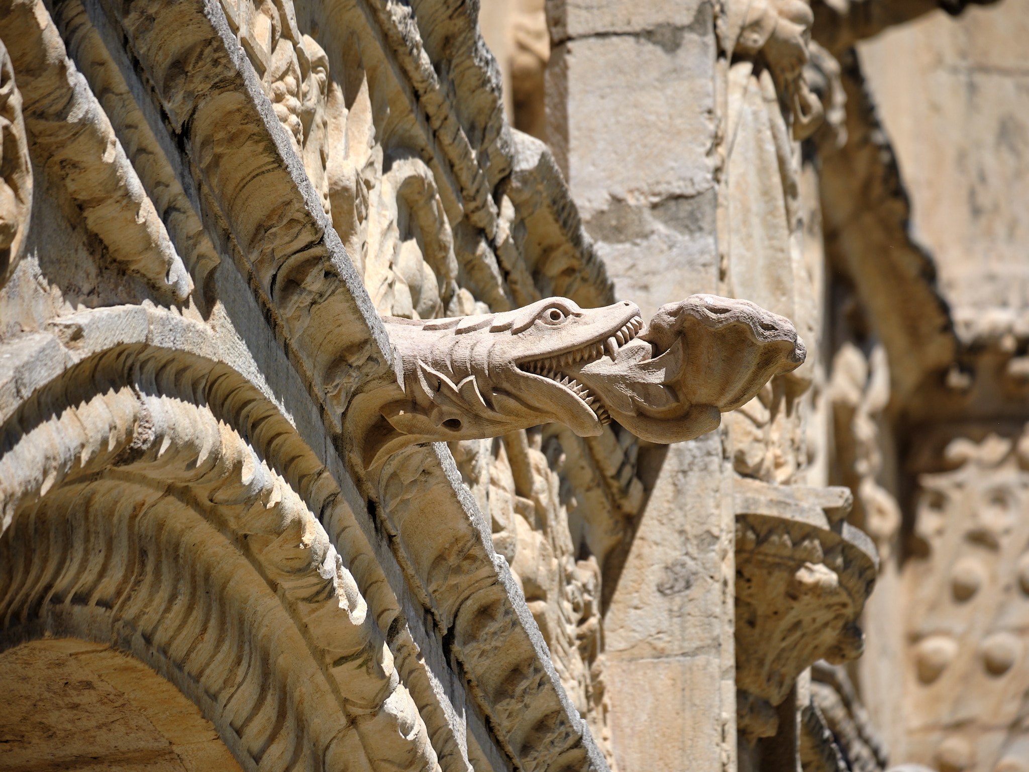 &lt;# a gargoyle of a snake eating a clam #&gt;