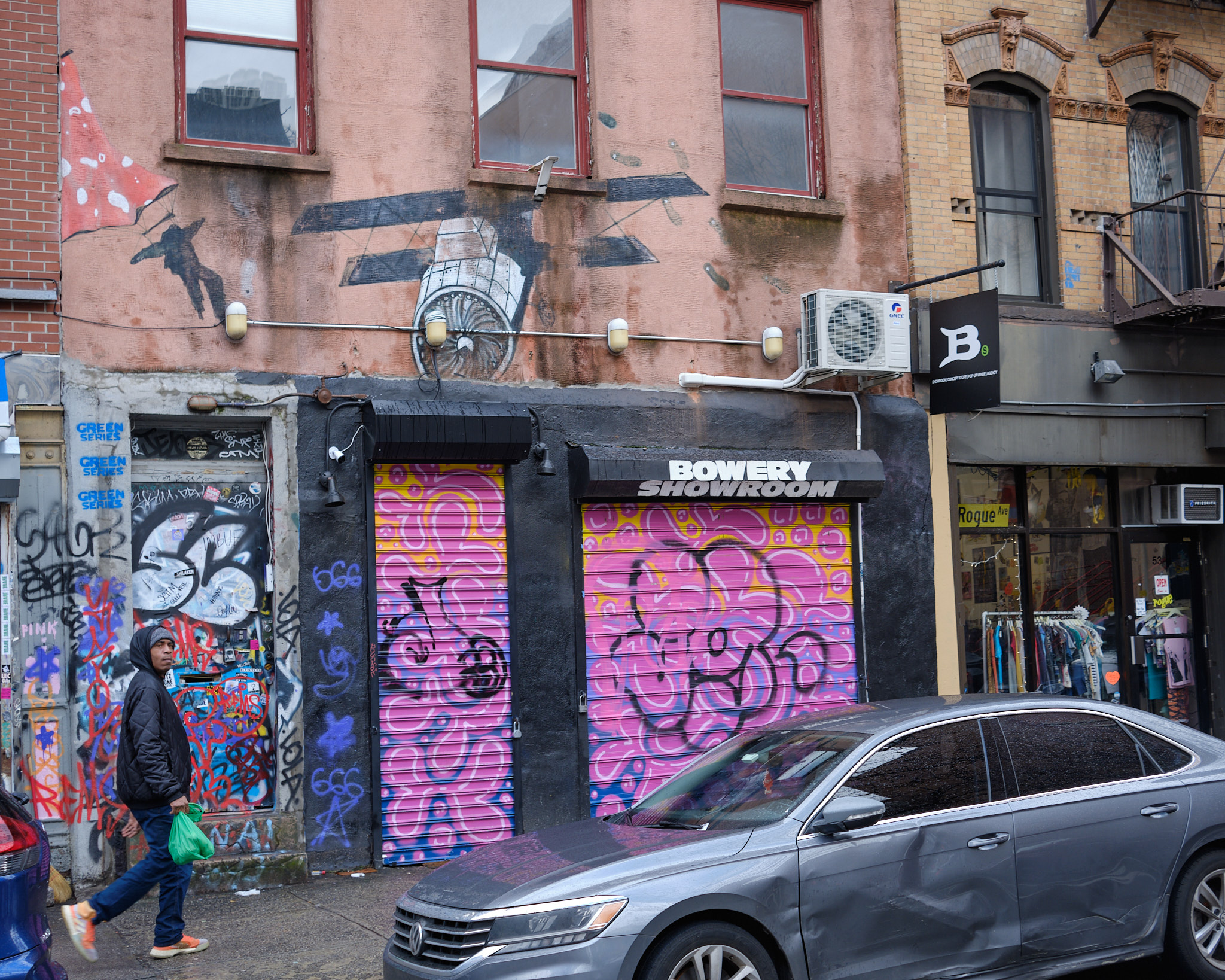 &lt;# A bright pink metal door covers a shop called the Bowery Showroom #&gt;