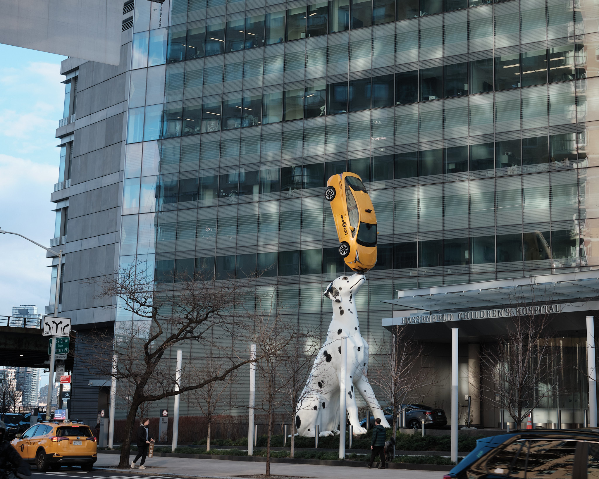 &lt;# Statue of a dog balancing a taxi on its nose#&gt;