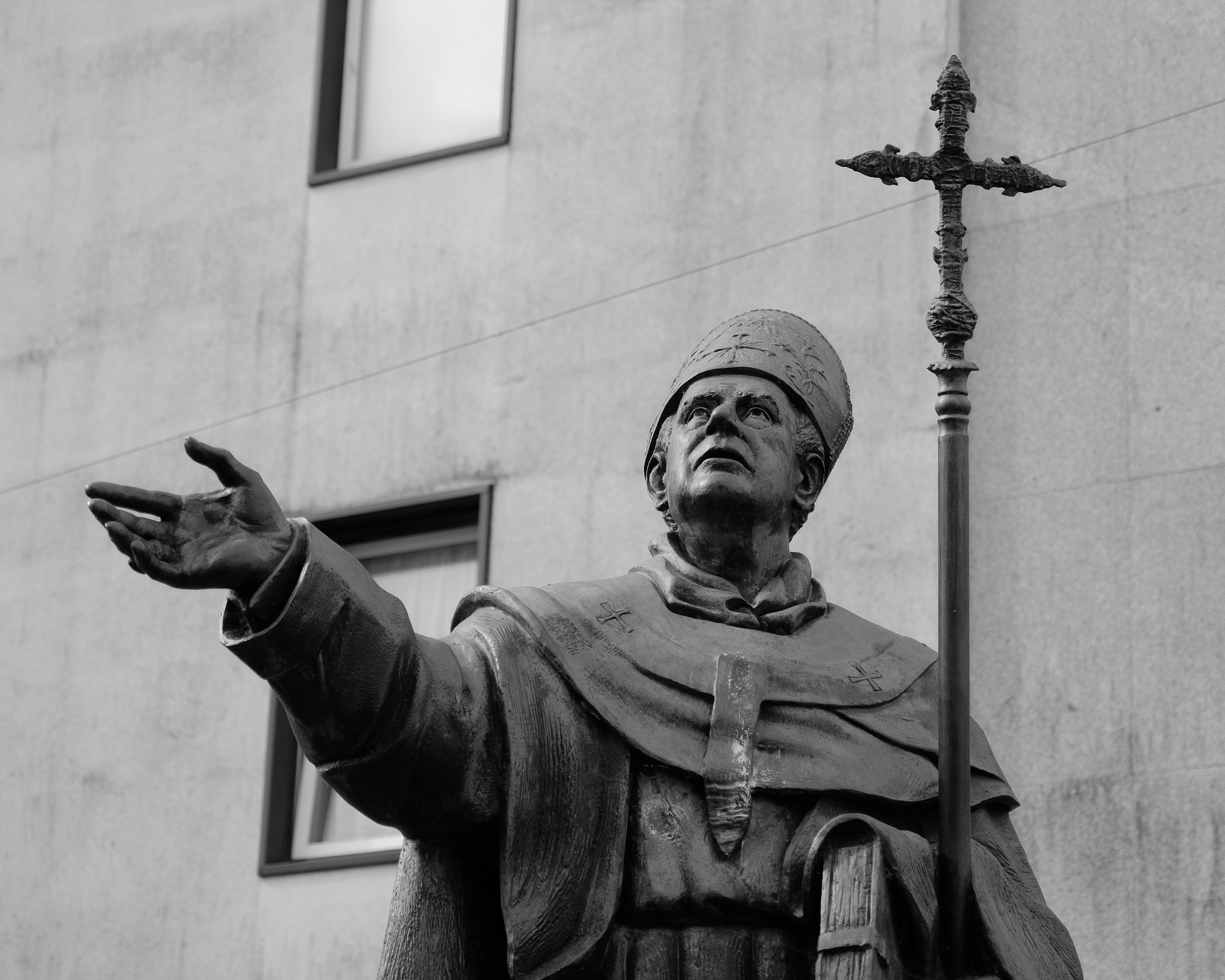 <# statue of priest looking up #>